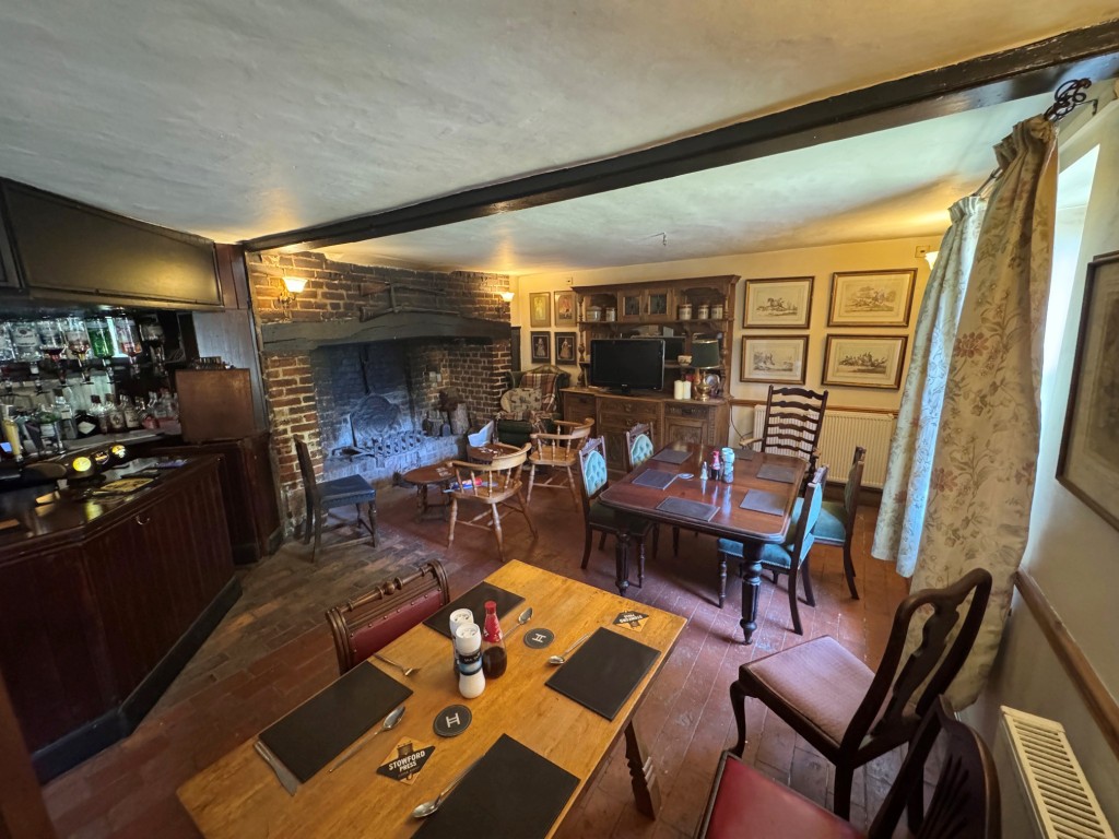Lot: 107 - PERIOD FREEHOLD FREEHOUSE ON 1.5 ACRE PLOT WITH POTENTIAL - Section of bar/seating area with Inglenook